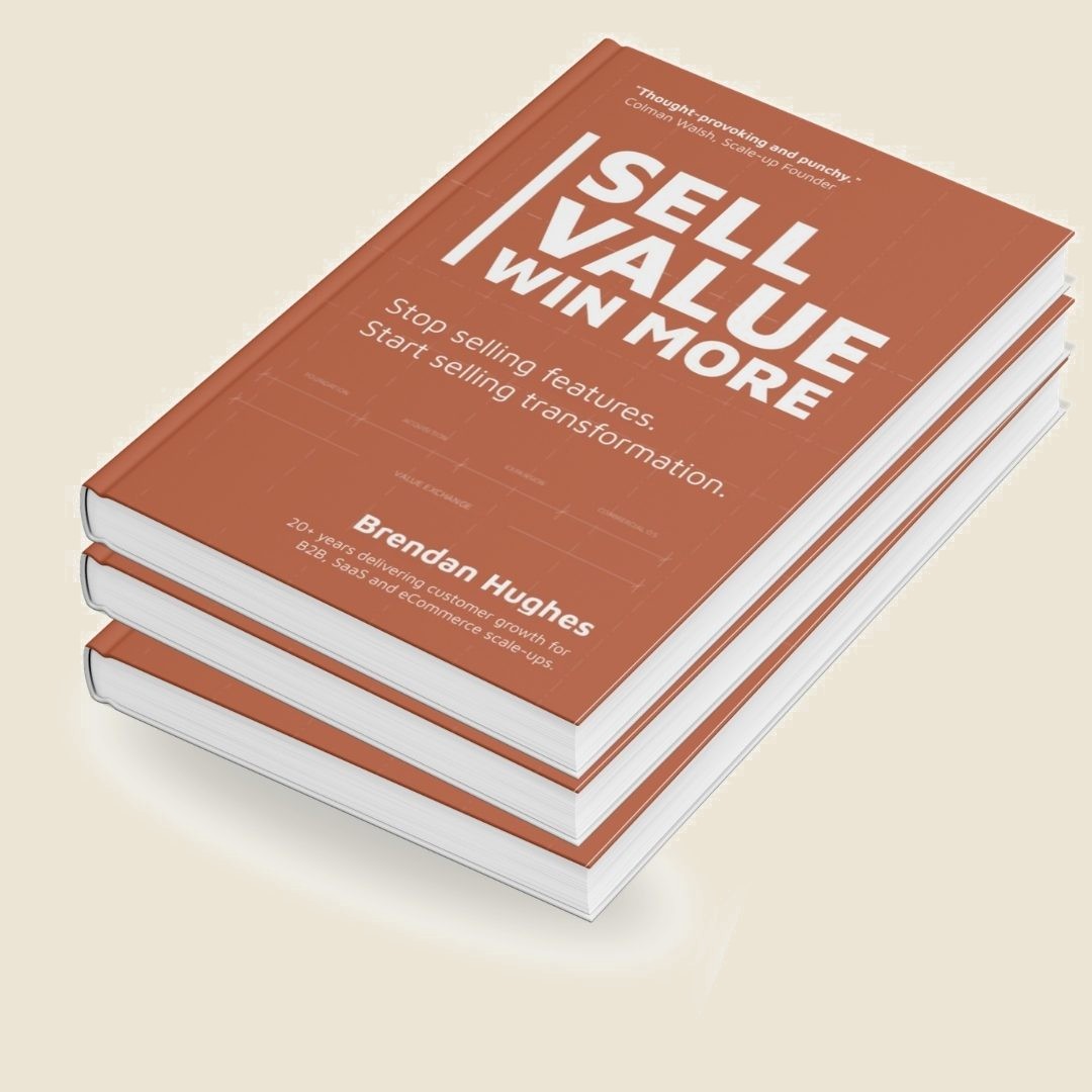 A stack of three copies of Sell Value. Win More. by Brendan Hughes, a terracotta hardback. The cover reads: stop selling features, start selling transformation.